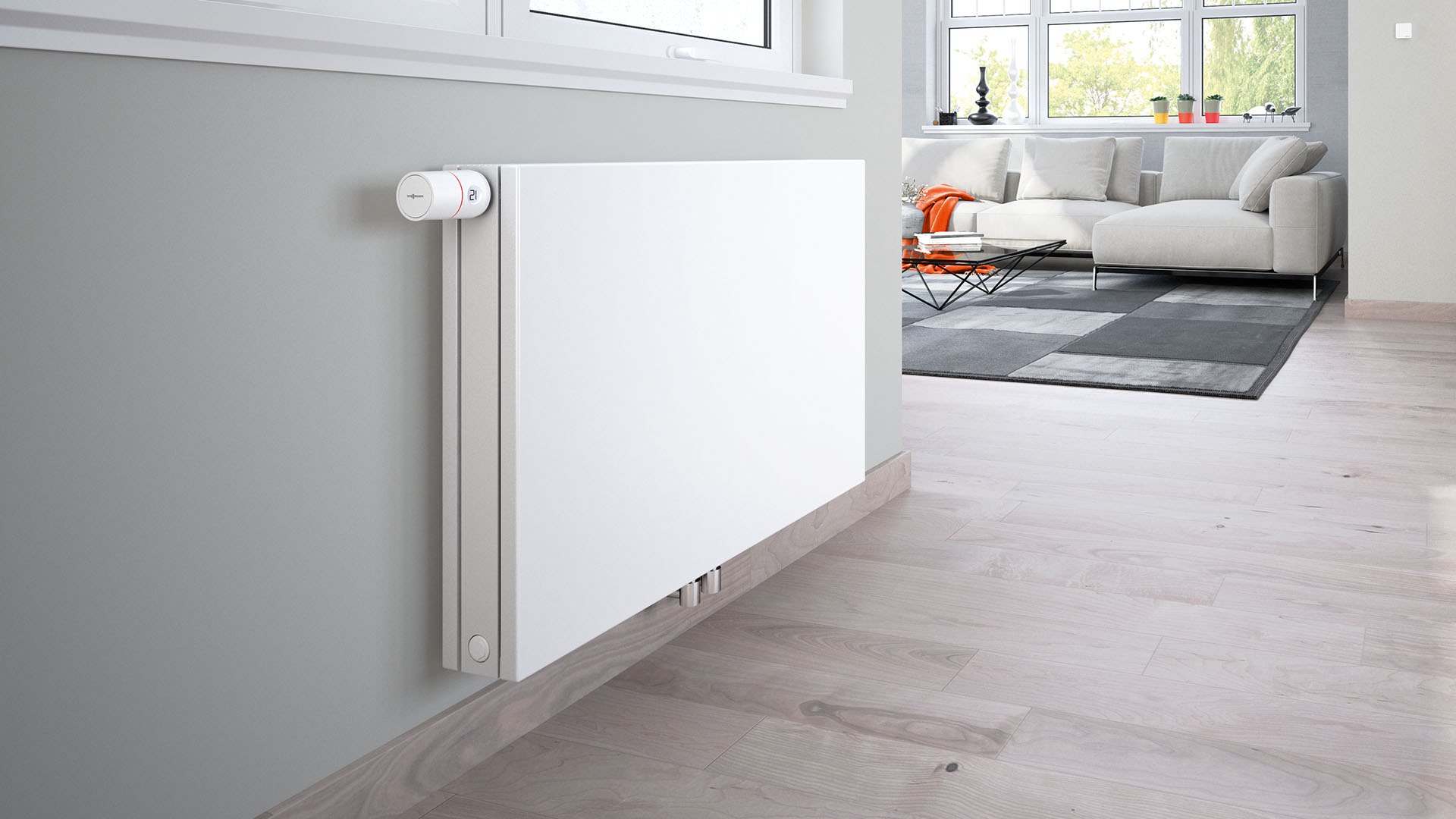 Imaginea prezintă un radiator dintr-o cameră de zi cu un termostat ViCare pentru un control individual convenabil al camerei.